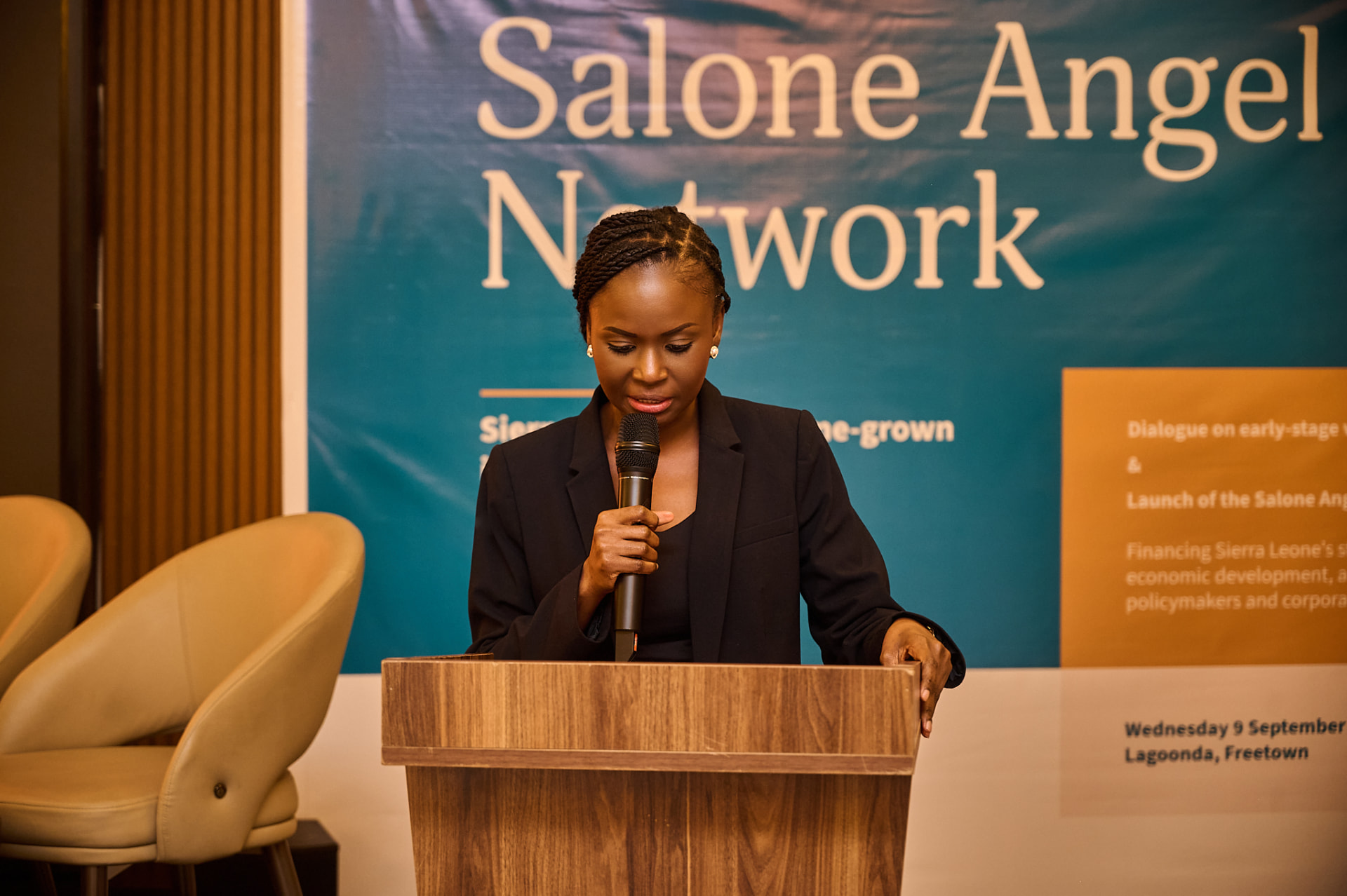 A woman delivering remarks from the lectern at the Salone Angel Network launch